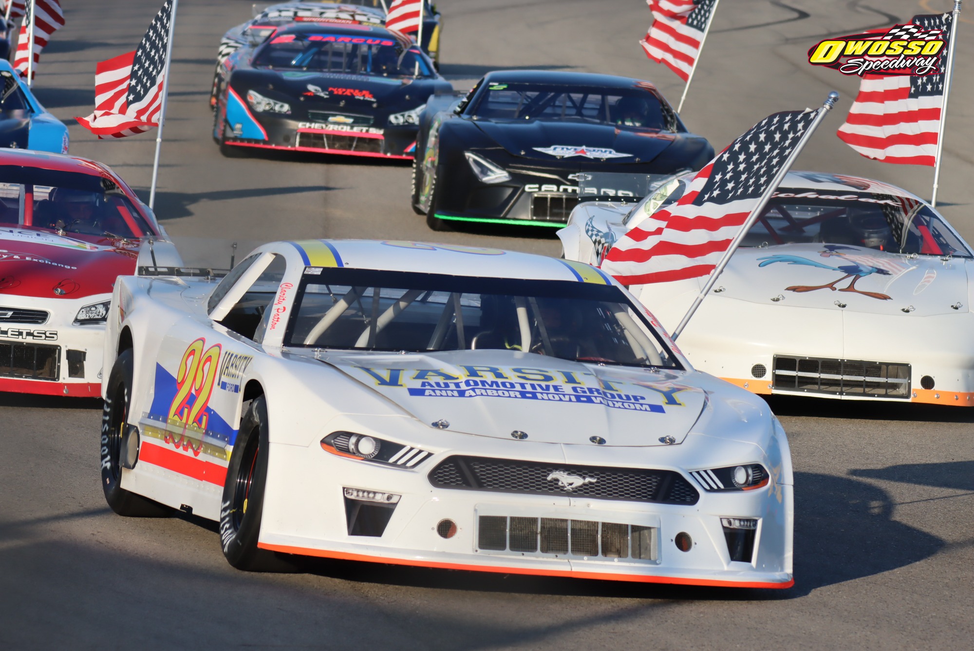The number 22 Mustang carrying flags on the track